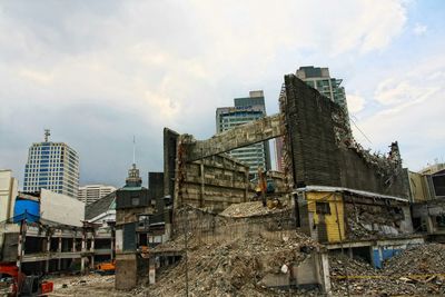 Buildings against cloudy sky