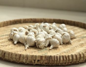 Close-up of garlic bulbs in basket at home