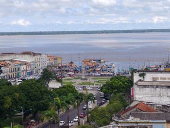 High angle view of buildings and sea against sky