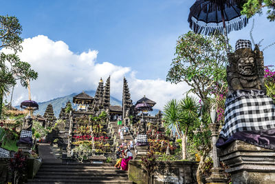 People outside temple against building