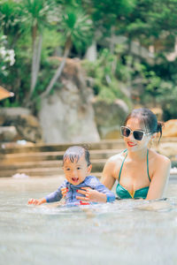 Portrait of mother and daughter on rock