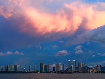 Cityscape against cloudy sky
