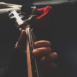 Cropped image of man playing guitar