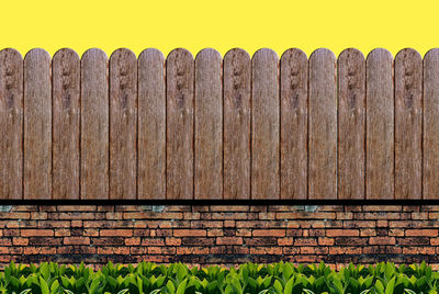 Close-up of rusty metal fence against wall