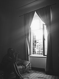 Woman looking through window