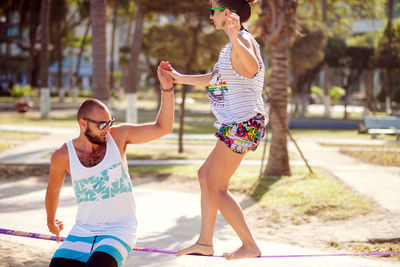 Woman slacklining at beach