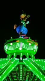 Low angle view of illuminated ferris wheel