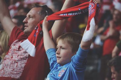 Father and son cheering at stadium