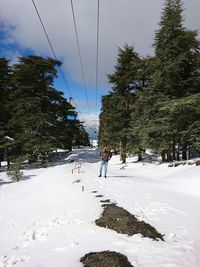 People walking in snow covered landscape