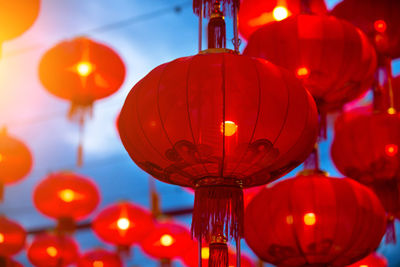 Low angle view of illuminated lanterns hanging at night