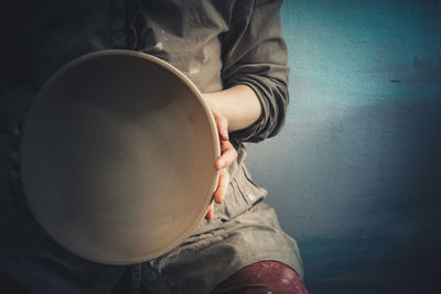 Close-up of man working against wall