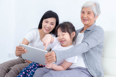 Happy friends sitting on laptop