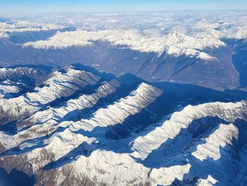 View from above over snow capped mountains in italy