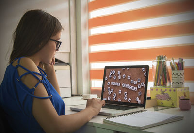 Woman using phone on table