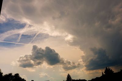 Low angle view of silhouette trees against sky