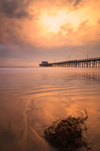 Scenic view of sea against orange sky