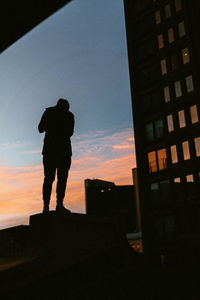 Silhouette woman standing against sky