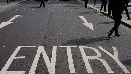 Low section of people walking on road