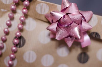 Close-up of ribbon bow and pearls on christmas present