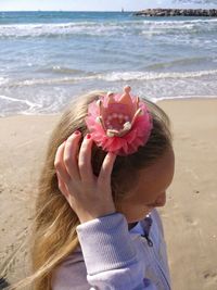 Close-up of girl hair clip standing at beach on sunny day