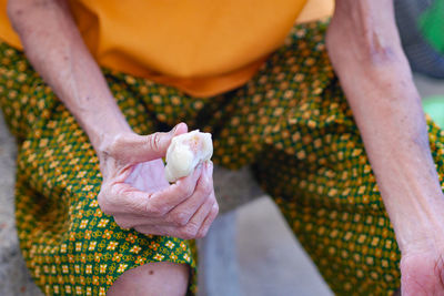 Midsection of woman holding hands