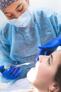 Dentist giving anesthetic injection to patient in clinic