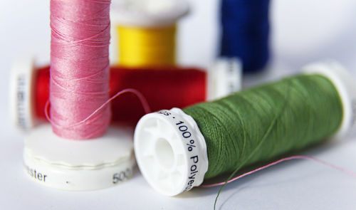 Sewing thread in different colors and 100 percent polyester