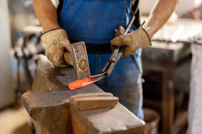 Close up view of heated metal and anvil. the blacksmith in the production process of metal products