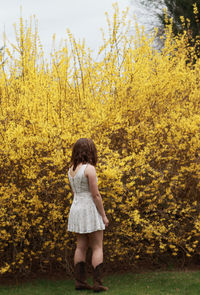 Full length of woman standing in park during autumn