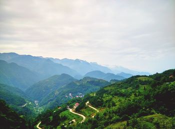 Scenic view of mountains against cloudy sky