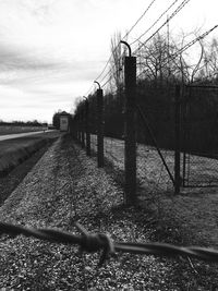 Railroad tracks on field against sky