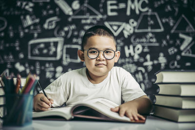 Portrait of boy with open book