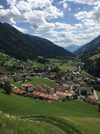 Aerial view of townscape and mountains against sky