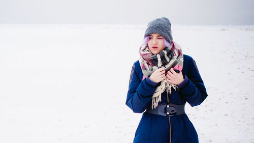 Full length of happy girl standing on snow