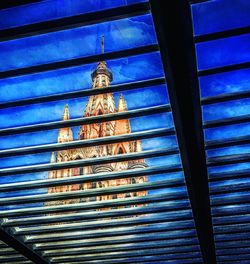 Low angle view of window against blue sky