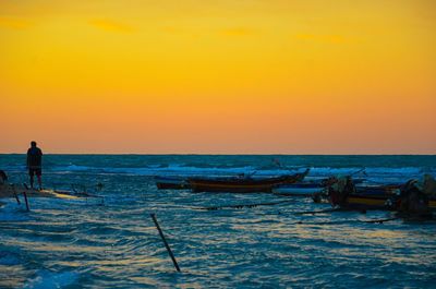 Scenic view of sea against orange sky