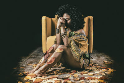 Young woman sitting on floor