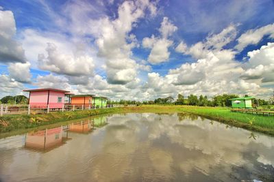 Panoramic view of lake and buildings against sky