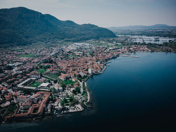 High angle view of townscape by sea against sky