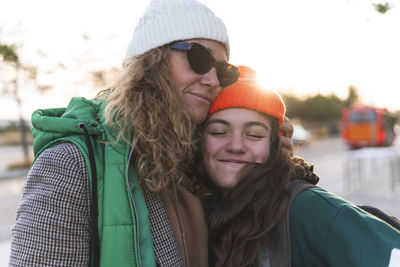 Mother and daughter embracing each other