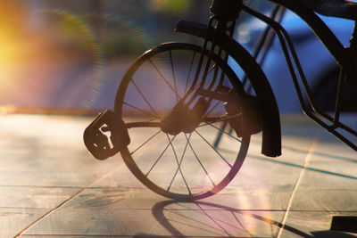 Close-up of bicycle wheel on floor