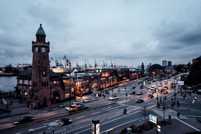 High angle view of city street against cloudy sky