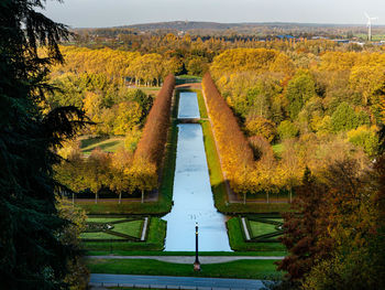 Elevated view on nice park with straight channel during colorful autumn