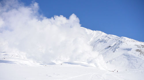 Scenic view of snow covered mountains against sky