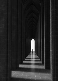 Full length of woman standing in corridor of building