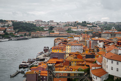 High angle view of river by buildings against sky