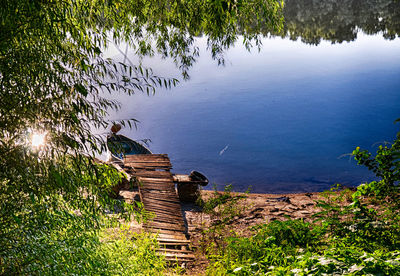 High angle view of wooden post by lake