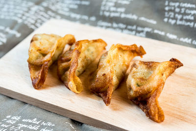 Close-up of fried dumplings on cutting board