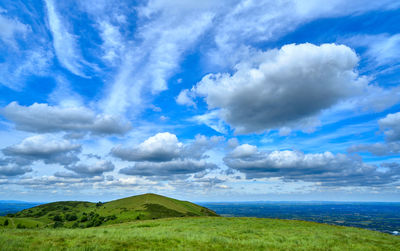 Scenic view of green landscape against sky