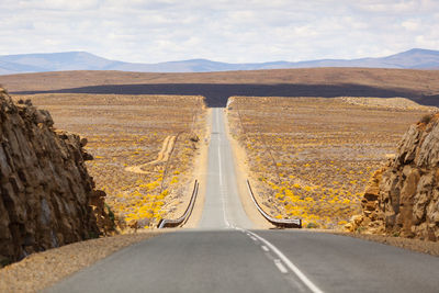 Road amidst landscape against sky